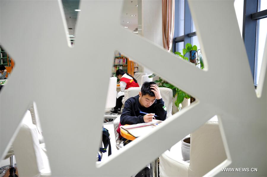 Students read books at Cangzhou Library during winter vacation in Cangzhou City, north China's Hebei Province, Feb. 4, 2017.